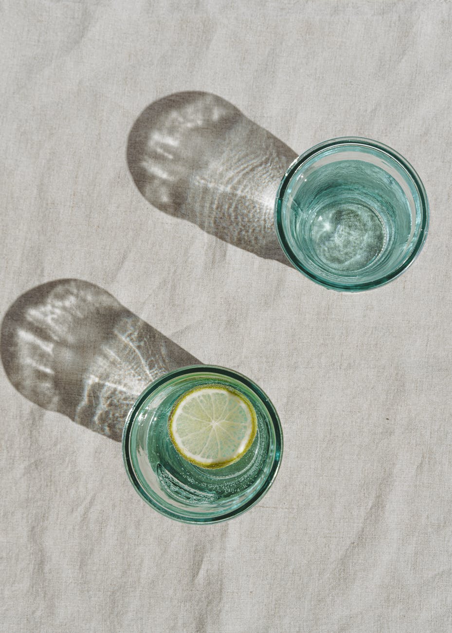 clear glasses with water and lemon