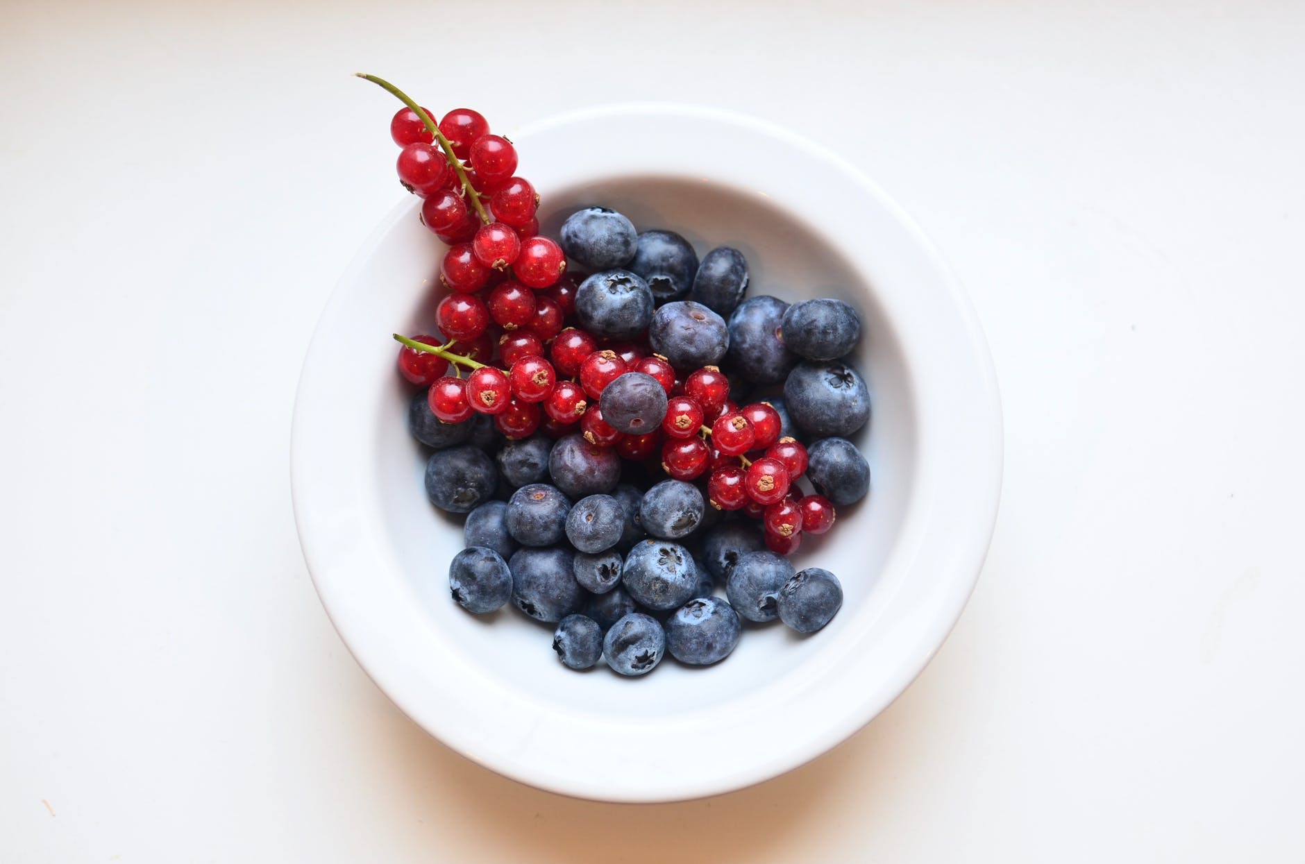 ripe appetizing berries in ceramic bowl